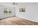 Cozy bedroom featuring a ceiling fan, hardwood floors, and a bright window with natural light at 107 Kingsmill Rd, Cary, NC 27511