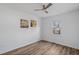 Serene bedroom featuring hardwood floors, a ceiling fan, and a window offering natural light at 107 Kingsmill Rd, Cary, NC 27511