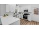 Bright and airy kitchen with white cabinets, stainless steel appliances, and ample counter space at 107 Kingsmill Rd, Cary, NC 27511