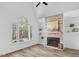 Bright living room with stone fireplace, hardwood floors, and large window offering scenic views at 107 Kingsmill Rd, Cary, NC 27511