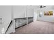 Bright upstairs space with staircase, window, plush carpet, and modern railing at 107 Kingsmill Rd, Cary, NC 27511