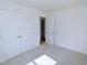 Well-lit bedroom with carpet, closet with double doors, and a doorway for convenient access at 108 Torain St, Hillsborough, NC 27278