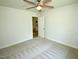 Bright bedroom features neutral carpet, a ceiling fan, and a convenient doorway for easy access at 108 Torain St, Hillsborough, NC 27278