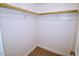 Walk-in closet boasts ample storage space with sturdy wooden rails and shelving units at 108 Torain St, Hillsborough, NC 27278