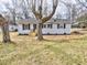 Inviting single-story home with light gray siding, black shutters, new front porch, and well-maintained front yard at 108 Torain St, Hillsborough, NC 27278
