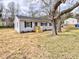 Charming single-story home with light gray siding, black shutters, new front porch, and freshly landscaped yard at 108 Torain St, Hillsborough, NC 27278