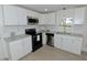 Well-lit kitchen boasts stainless steel appliances and modern countertops at 108 Torain St, Hillsborough, NC 27278