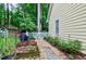Backyard space with a stone paver path leading to a small, decorative white picket fence at 109 Reton Ct, Cary, NC 27513