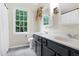 Bathroom with double sink vanity and a large window providing natural light and outdoor views at 109 Reton Ct, Cary, NC 27513