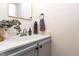 Powder room featuring a vessel sink, a gold-toned mirror, and eucalyptus decor at 109 Reton Ct, Cary, NC 27513