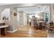 Dining area featuring hardwood floors that connect to the kitchen with white cabinets at 109 Reton Ct, Cary, NC 27513