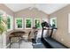 Exercise room featuring multiple windows, a treadmill and exercise bike at 109 Reton Ct, Cary, NC 27513
