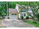 Yellow two-story home featuring an attached garage, landscaped yard, and a quaint front entrance at 109 Reton Ct, Cary, NC 27513