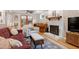 Bright living room with a fireplace, hardwood floors and comfortable seating at 109 Reton Ct, Cary, NC 27513