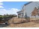 View of the backyard with lawn, rod iron fencing and view of the covered patio at 110 Cambria Ln, Morrisville, NC 27560