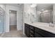 Bathroom with a double vanity, dark wood cabinets, and a shower with glass doors at 110 Cambria Ln, Morrisville, NC 27560