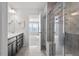 Bright bathroom featuring a double vanity, glass shower, and neutral tile flooring at 110 Cambria Ln, Morrisville, NC 27560