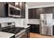 Stylish kitchen featuring stainless steel appliances and dark wood cabinets at 110 Cambria Ln, Morrisville, NC 27560