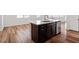 Kitchen island with a stainless steel dishwasher and sink with wood cabinets at 110 Cambria Ln, Morrisville, NC 27560