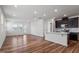 Open kitchen and living area with stainless steel appliances and a large center island at 110 Cambria Ln, Morrisville, NC 27560