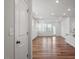 Open-concept living room with recessed lighting, hardwood floors, and access to the back patio at 110 Cambria Ln, Morrisville, NC 27560