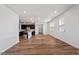 Open concept living room with a view into the kitchen area and wood floors at 110 Cambria Ln, Morrisville, NC 27560