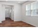 Bright living room featuring wood floors and large windows, providing ample natural light at 110 Cambria Ln, Morrisville, NC 27560