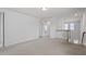 Spacious loft area with neutral carpet and a view of the staircase and windows at 110 Cambria Ln, Morrisville, NC 27560
