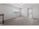 Carpeted upstairs loft featuring natural light, a view of the neighborhood, and a staircase at 110 Cambria Ln, Morrisville, NC 27560