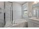 Bright bathroom features marble floors, a glass-enclosed shower, and a soaking tub at 1112 Leatherstone Ln, Fuquay Varina, NC 27526