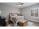 Cozy bedroom featuring a ceiling fan, a patterned quilt, and a trunk at the foot of the bed at 1112 Leatherstone Ln, Fuquay Varina, NC 27526