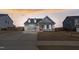 Charming single-Gathering home with a two car garage, manicured lawn, and a welcoming red front door at 1112 Leatherstone Ln, Fuquay Varina, NC 27526