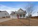 Charming single-Gathering home with a two car garage, manicured lawn, and a welcoming red front door at 1112 Leatherstone Ln, Fuquay Varina, NC 27526