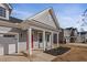 Inviting front porch featuring white columns and a bright red door at 1112 Leatherstone Ln, Fuquay Varina, NC 27526