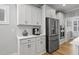 A bright kitchen features white cabinets, stainless steel appliances, and a coffee bar at 1112 Leatherstone Ln, Fuquay Varina, NC 27526