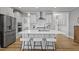 A spacious kitchen island featuring stainless appliances and room to eat and gather at 1112 Leatherstone Ln, Fuquay Varina, NC 27526