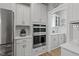A bright kitchen features white cabinets, stainless steel appliances, and a butler's pantry at 1112 Leatherstone Ln, Fuquay Varina, NC 27526