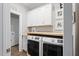 Functional laundry room featuring a modern washer and dryer, storage, and a butcher block counter at 1112 Leatherstone Ln, Fuquay Varina, NC 27526