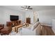 Bright living room with hardwood floors, a light couch, and a ceiling fan at 1112 Leatherstone Ln, Fuquay Varina, NC 27526