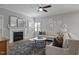 Inviting living room featuring a fireplace, neutral-toned sofas, and stylish decor at 1112 Leatherstone Ln, Fuquay Varina, NC 27526