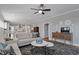 Open-concept living room with fireplace, plush seating, and view into the kitchen at 1112 Leatherstone Ln, Fuquay Varina, NC 27526