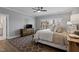 Cozy main bedroom with soft lighting, natural wood accents, and plush bedding at 1112 Leatherstone Ln, Fuquay Varina, NC 27526