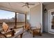 Relaxing screened-in porch with ceiling fan and an outdoor seating area at 1112 Leatherstone Ln, Fuquay Varina, NC 27526
