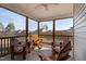 Inviting screened-in porch with a ceiling fan and an outdoor seating area at 1112 Leatherstone Ln, Fuquay Varina, NC 27526