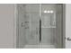 Modern shower with glass doors, a shower head, and a built-in shelf at 1112 Leatherstone Ln, Fuquay Varina, NC 27526