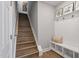 Bright stairway with wood floors, white wainscoting and bench seating at 1112 Leatherstone Ln, Fuquay Varina, NC 27526