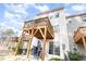 A cozy two-story home with a spacious deck perfect for relaxing outdoors under the bright, cloudy sky at 1154 Romeria Dr, Durham, NC 27713