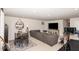 Finished basement features a recreation space with a lounge area, TV, exercise equipment, and a dining table at 1154 Romeria Dr, Durham, NC 27713