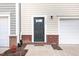 Inviting front door with brick accents and manicured landscaping at 1154 Romeria Dr, Durham, NC 27713