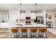 Modern kitchen with white cabinets, stainless steel appliances, and quartz countertops at 1154 Romeria Dr, Durham, NC 27713
